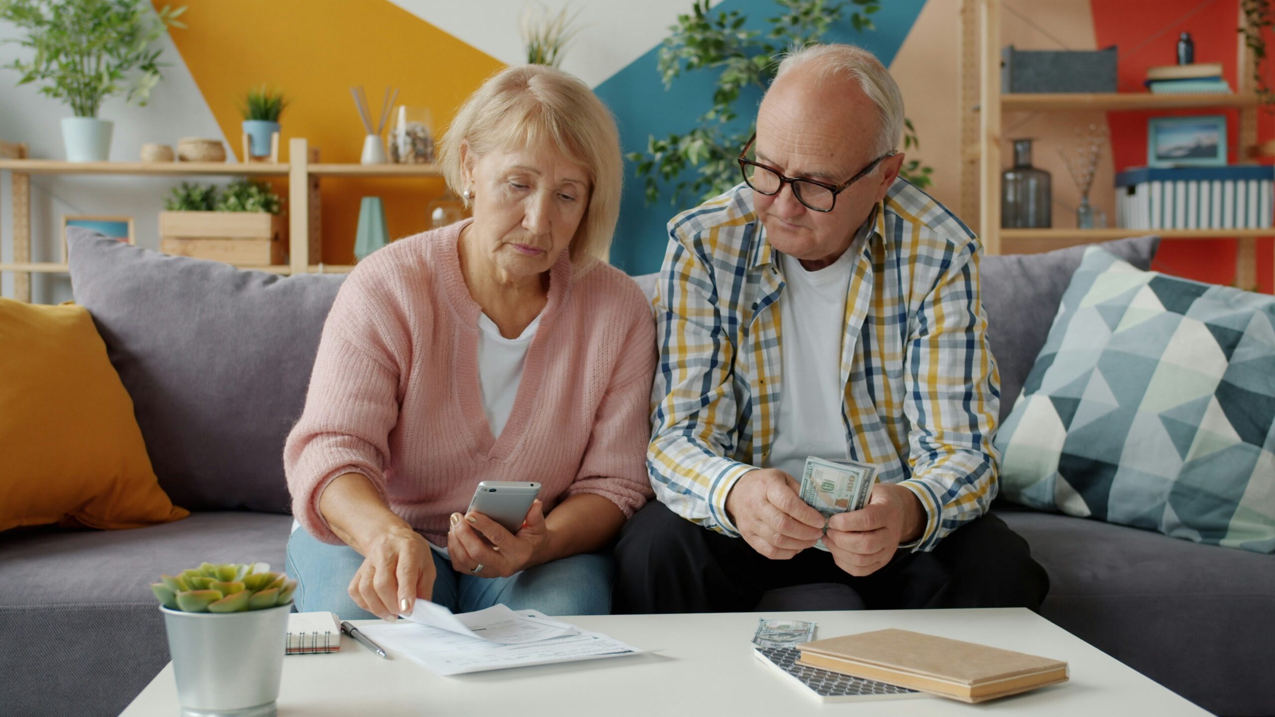 Elderly couple reviewing their savings and finances at home
